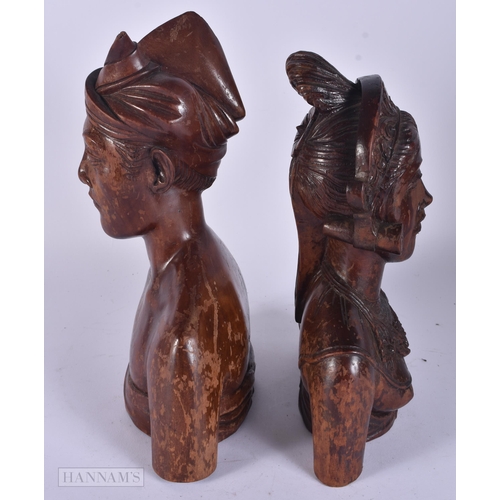 343 - A PAIR OF SOUTHEAST ASIAN WOODEN BUSTS. 30 cm x 15 cm.