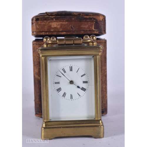 346 - AN ANTIQUE MINIATURE BRASS CARRIAGE CLOCK. 11 cm high inc handle.