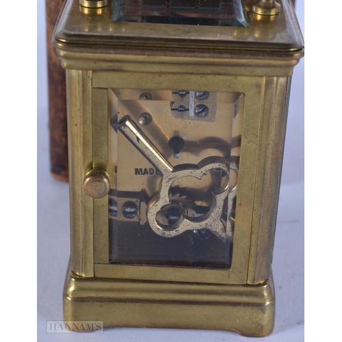346 - AN ANTIQUE MINIATURE BRASS CARRIAGE CLOCK. 11 cm high inc handle.