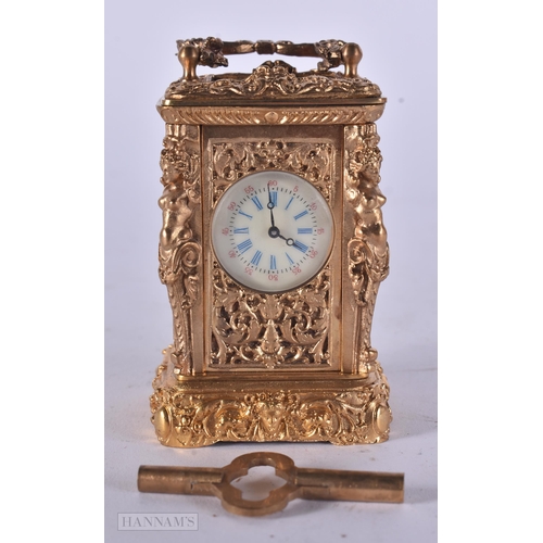 347 - A MINIATURE BRASS CARRIAGE CLOCK. 9 cm high inc handle.