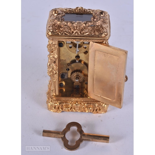 347 - A MINIATURE BRASS CARRIAGE CLOCK. 9 cm high inc handle.