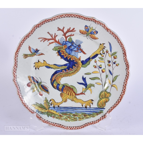 355 - AN UNUSUAL ANTIQUE FRENCH FAIENCE DRAGON PLATE. 23.5 cm wide.