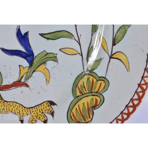 355 - AN UNUSUAL ANTIQUE FRENCH FAIENCE DRAGON PLATE. 23.5 cm wide.