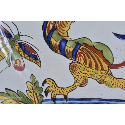 355 - AN UNUSUAL ANTIQUE FRENCH FAIENCE DRAGON PLATE. 23.5 cm wide.