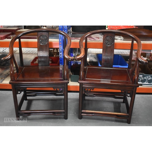 423 - A PAIR OF CHINESE QING DYNASTY CARVED HARDWOOD ARM CHAIRS. 90cm x 60cm.