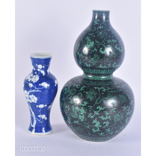 430 - A 19TH CENTURY CHINESE BLUE AND WHITE PORCELAIN PRUNUS VASE Kangxi style, together with a famille no... 