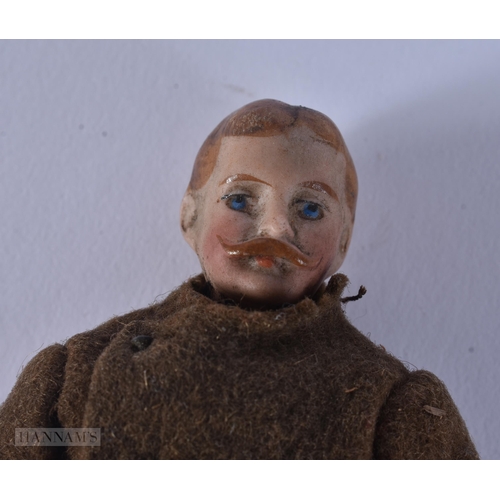 439 - AN UNUSUAL WWII MILITARY PORCELAIN HEADED DOLL. 13 cm long.