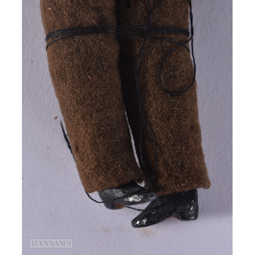 439 - AN UNUSUAL WWII MILITARY PORCELAIN HEADED DOLL. 13 cm long.