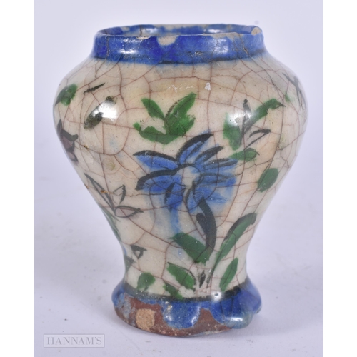 444 - AN EARLY ISLAMIC PERSIAN QAJAR POTTERY VASE. 11 cm high.