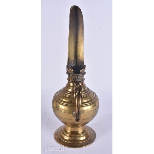 448 - AN UNUSUAL ANTIQUE MIDDLE EASTERN HIGH SPOUTED EWER. 38 cm high.