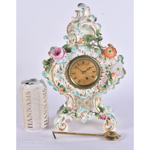 449 - A 19TH CENTURY FRENCH PORCELAIN ROCOCO MANTEL CLOCK encrusted with flowers. 30 cm x 17 cm.