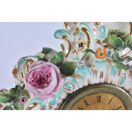 449 - A 19TH CENTURY FRENCH PORCELAIN ROCOCO MANTEL CLOCK encrusted with flowers. 30 cm x 17 cm.