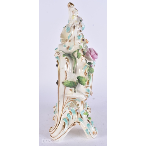 449 - A 19TH CENTURY FRENCH PORCELAIN ROCOCO MANTEL CLOCK encrusted with flowers. 30 cm x 17 cm.