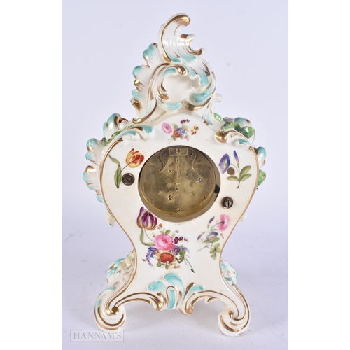449 - A 19TH CENTURY FRENCH PORCELAIN ROCOCO MANTEL CLOCK encrusted with flowers. 30 cm x 17 cm.