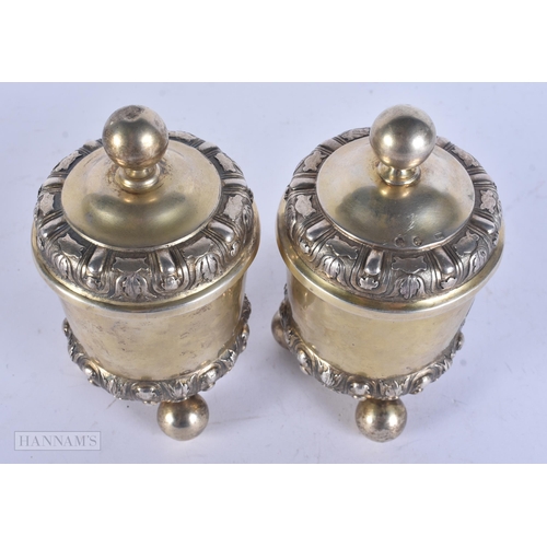 453 - A PAIR OF ANTIQUE CONTINENTAL SILVER GILT CUPS AND COVERS. 14 cm high.