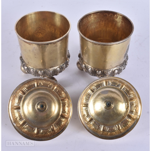 453 - A PAIR OF ANTIQUE CONTINENTAL SILVER GILT CUPS AND COVERS. 14 cm high.