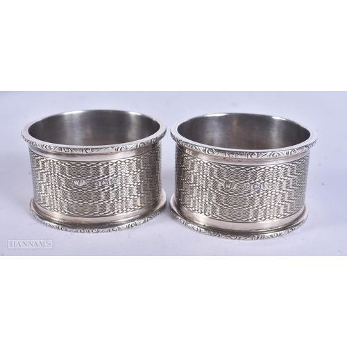 465 - A PAIR OF CASED ANTIQUE SILVER NAPKIN RINGS. 70 grams. 5 cm wide.