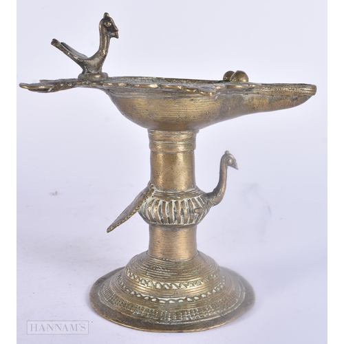 475 - AN ANTIQUE INDIAN BRONZE OIL BURNER together with two bronze mounts. Largest 25 cm wide. (3)