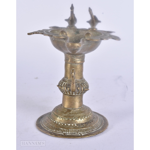 475 - AN ANTIQUE INDIAN BRONZE OIL BURNER together with two bronze mounts. Largest 25 cm wide. (3)