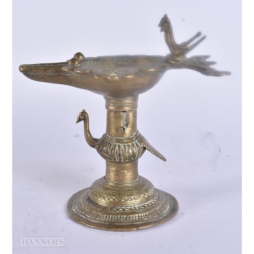 475 - AN ANTIQUE INDIAN BRONZE OIL BURNER together with two bronze mounts. Largest 25 cm wide. (3)