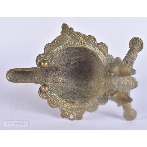 475 - AN ANTIQUE INDIAN BRONZE OIL BURNER together with two bronze mounts. Largest 25 cm wide. (3)