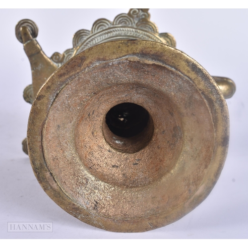 475 - AN ANTIQUE INDIAN BRONZE OIL BURNER together with two bronze mounts. Largest 25 cm wide. (3)