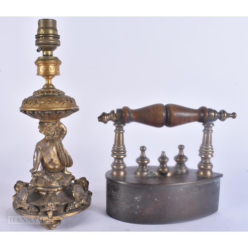 488 - AN ANTIQUE IRON together with a French bronze candlestick lamp. Largest 26.5 cm high. (2)