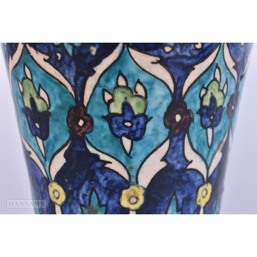 511 - A PERSIAN ISLAMIC FAIENCE POTTERY BEAKER. 13 cm high.