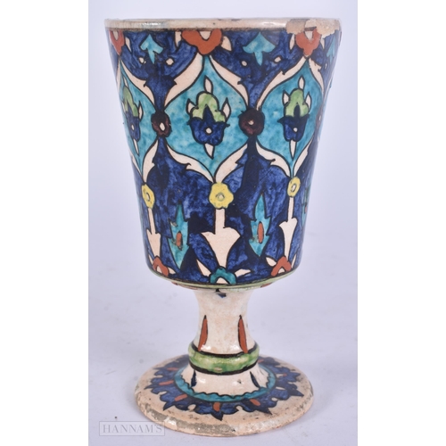 511 - A PERSIAN ISLAMIC FAIENCE POTTERY BEAKER. 13 cm high.