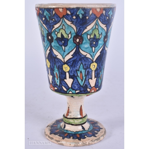 511 - A PERSIAN ISLAMIC FAIENCE POTTERY BEAKER. 13 cm high.