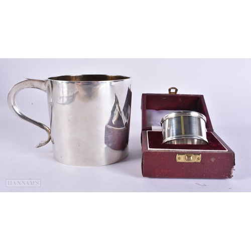 905 - AN ANTIQUE SILVER MUG together with a boxed silver napkin ring. 248 grams. Largest 8 cm x 12 cm. (2)