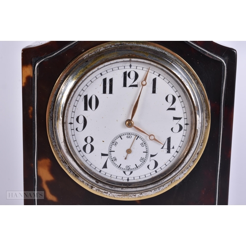 909 - A LATE VICTORIAN/EDWARDIAN SILVER MOUNTED TORTOISESHELL CLOCK with silver feet. 12 cm x 8 cm.