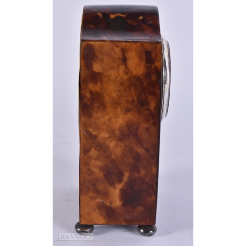 909 - A LATE VICTORIAN/EDWARDIAN SILVER MOUNTED TORTOISESHELL CLOCK with silver feet. 12 cm x 8 cm.