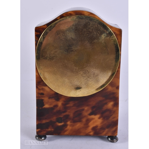 909 - A LATE VICTORIAN/EDWARDIAN SILVER MOUNTED TORTOISESHELL CLOCK with silver feet. 12 cm x 8 cm.