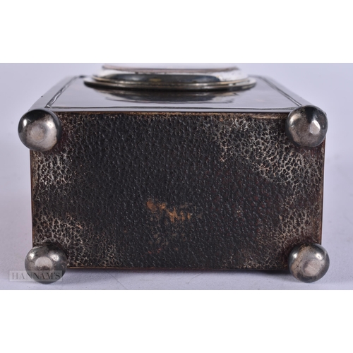 909 - A LATE VICTORIAN/EDWARDIAN SILVER MOUNTED TORTOISESHELL CLOCK with silver feet. 12 cm x 8 cm.