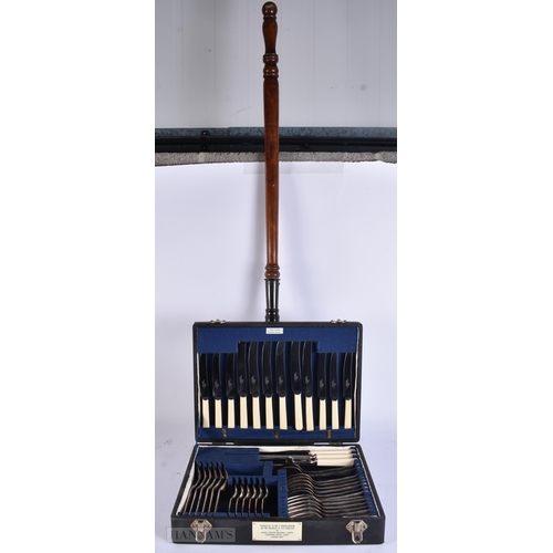 923 - A LARGE ANTIQUE WARMING PAN together with a canteen of cutlery. Largest 120 cm long. (2)