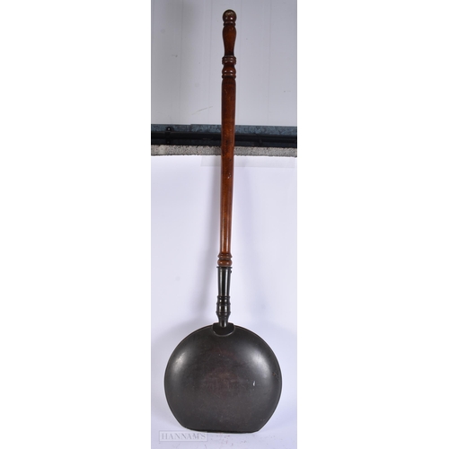 923 - A LARGE ANTIQUE WARMING PAN together with a canteen of cutlery. Largest 120 cm long. (2)