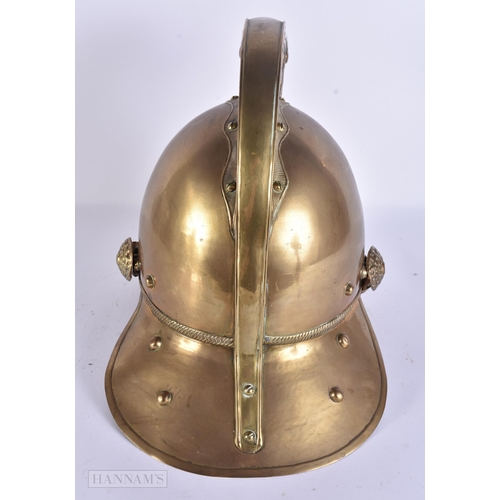 936 - A BRASS FIREMANS HELMET. 28 cm x 24 cm.
