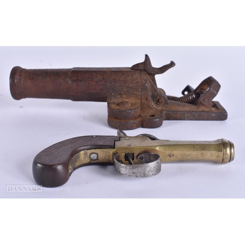 938 - A VERY RARE ANTIQUE CAST IRON PISTOL TRAP together with a smaller antique pistol. Largest 18 cm wide... 