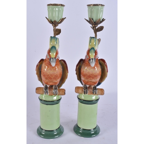 263 - A PAIR OF PARROT POTTERY CANDLESTICKS. 29 cm high.