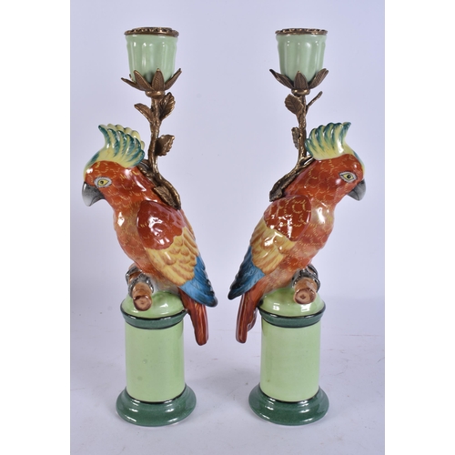 263 - A PAIR OF PARROT POTTERY CANDLESTICKS. 29 cm high.