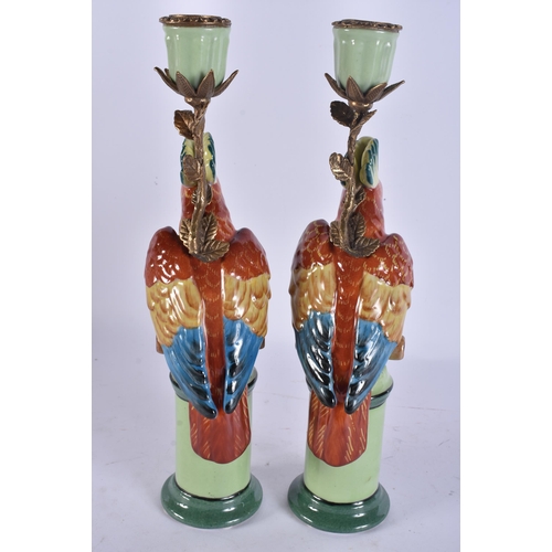 263 - A PAIR OF PARROT POTTERY CANDLESTICKS. 29 cm high.