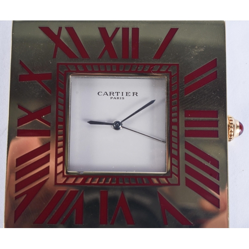 268 - A CARTIER MAROON ENAMELLED STRUT CLOCK. 6.75 cm x 5 cm.
