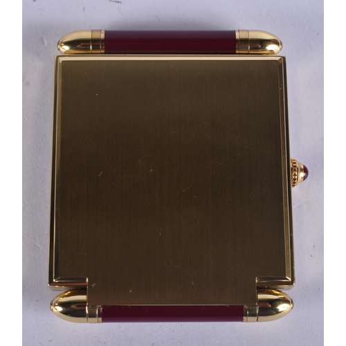 268 - A CARTIER MAROON ENAMELLED STRUT CLOCK. 6.75 cm x 5 cm.