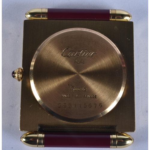 268 - A CARTIER MAROON ENAMELLED STRUT CLOCK. 6.75 cm x 5 cm.