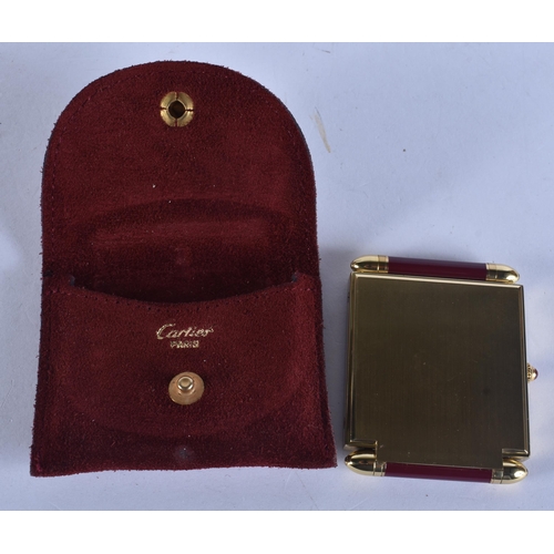 268 - A CARTIER MAROON ENAMELLED STRUT CLOCK. 6.75 cm x 5 cm.