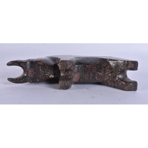 271 - A STYLISH PUDDINGSTONE CARVED ABSTRACT FIGURE OF A BULL. 17 cm wide.