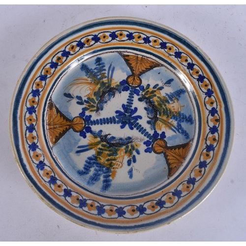 289 - AN ANTIQUE CONTINENTAL DELFT FAIENCE PLATE together with a faience font. Largest 29 cm long. (2)