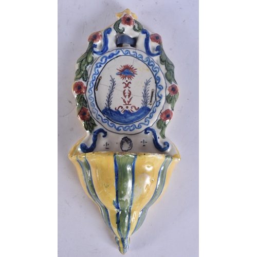 289 - AN ANTIQUE CONTINENTAL DELFT FAIENCE PLATE together with a faience font. Largest 29 cm long. (2)