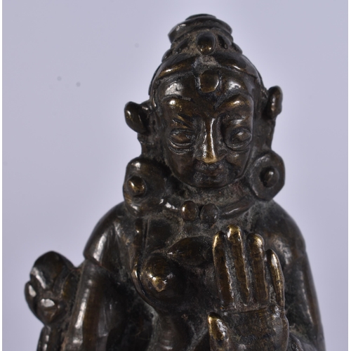 14 - AN 18TH CENTURY INDIAN BRONZE FIGURE OF A DEITY modelled upon a stepped base. 12.5 cm high.